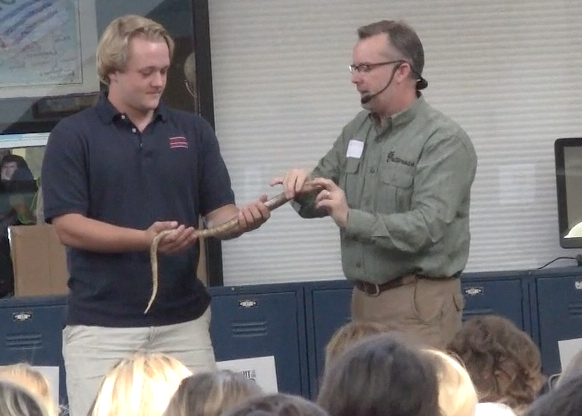 William Kleinheinz holds a snake with Critter Man.