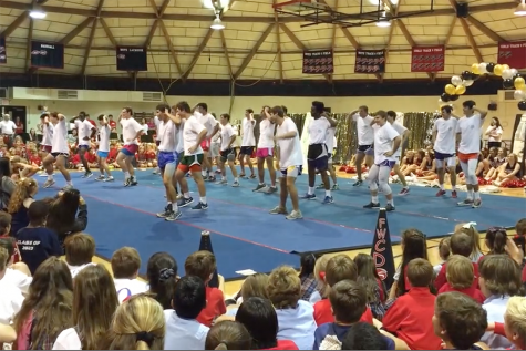 Senior boys worked with varsity cheerleaders for about five hours over five different practice days to perfect their Man Cheer routine for the Homecoming Pep Rally. 