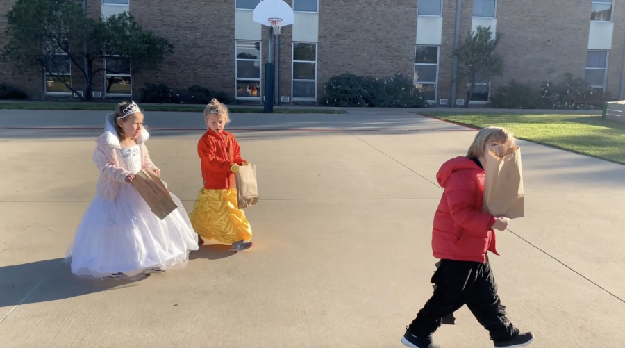 Junior+Kindergarten+students+walks+by+the+Middle+School+on+their+way+to+trick-or-treat+and+sing+in+the+Patton+Field+House