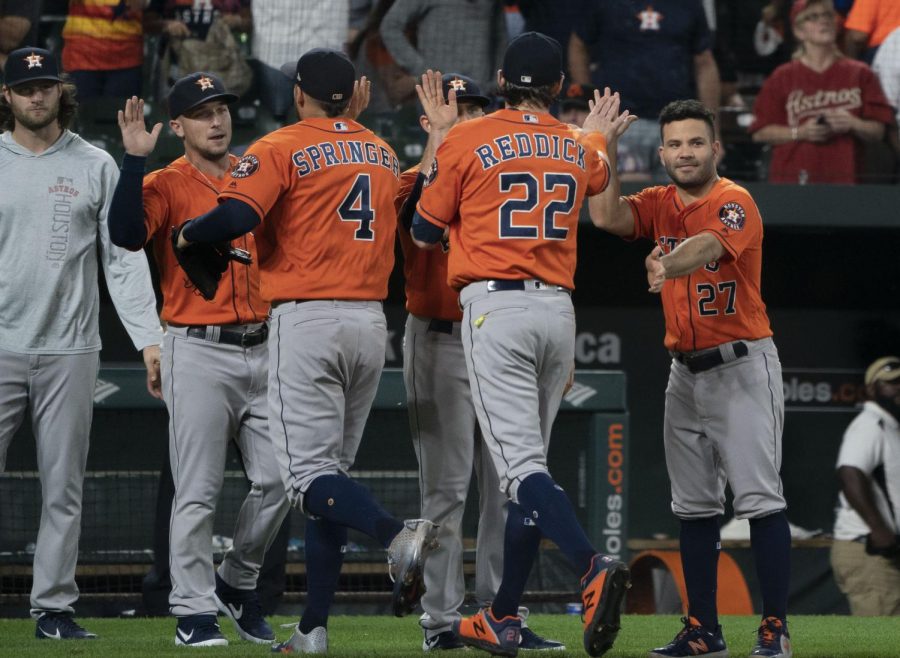 Astros players celebrate together during a 2018 game. 