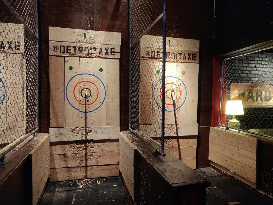 Axe throwers stand at the end of the stall and throw at the bullseye and the two blue dots above the rings, the kill shots.