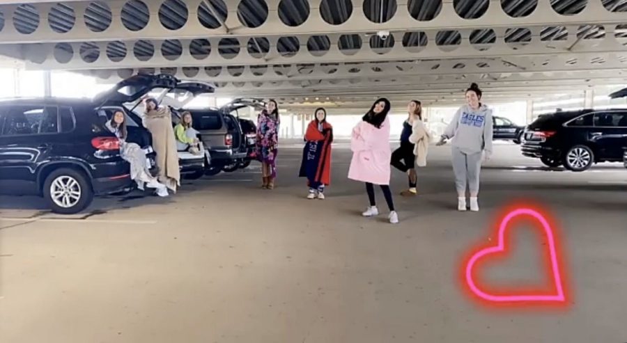 Junior girls meet up in their cars and sit in their trunks six feet apart to maintain social distancing guidelines.