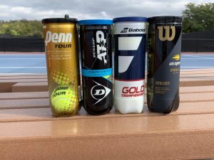 A display of the four tennis ball brands, Wilson, Penn, Babolat, and Dunlop before they are put through their test.