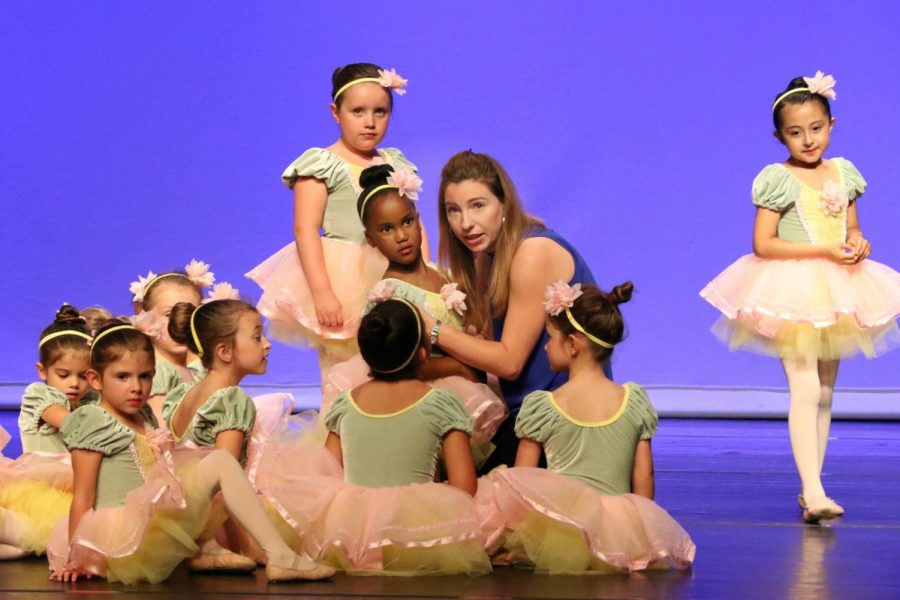 Natalie Bracken 05 helps ballet students before the recital. Photo courtesy of Natalie Bracken 05.