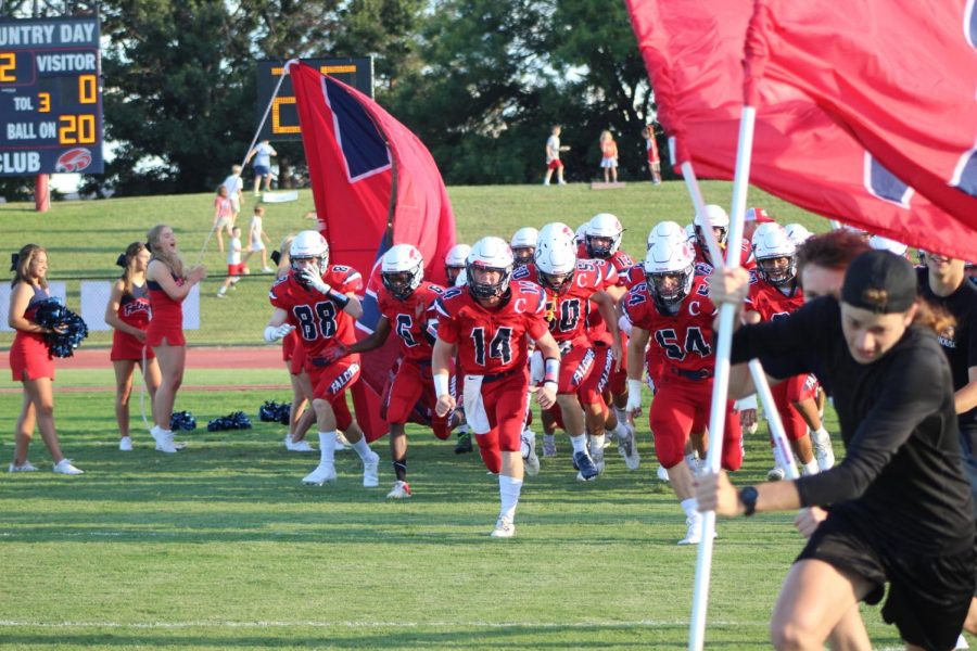 The FWCD football team charges onto the field before being defeated by St. Marks, 106 to 2.