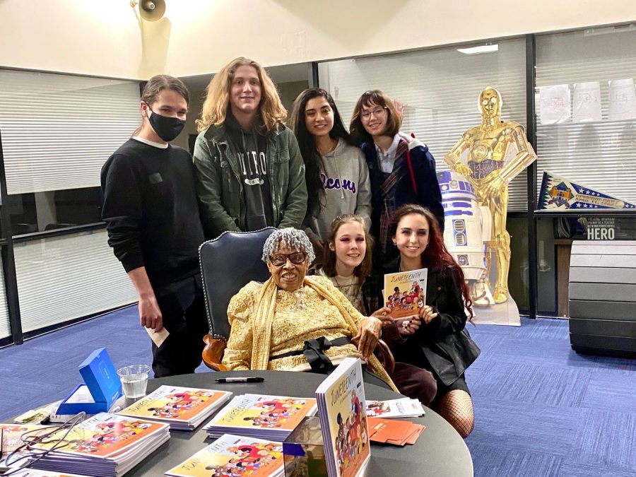 Opal Lee takes a photo with some Upper School students, and C3-PO and R2-D2, after her forum.