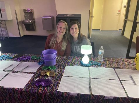 Stefanie Luedtke (Left) and Jennifer Giroir (Right) check students into the Student Councils Mardi Gras party last March. Luedtke and Giroir are Student Council co-sponsors and good friends. (Photo Courtesy Stefanie Luedtke)