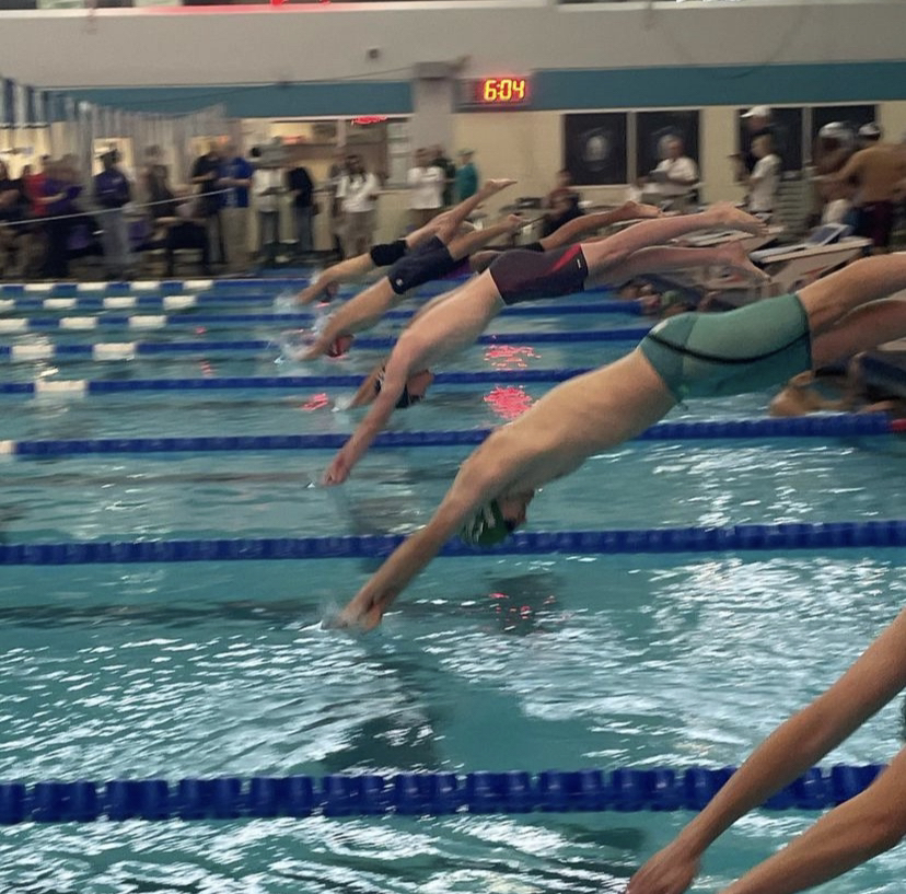 Chris Baker 23 competing in his 100-Yard Freestyle relay race.