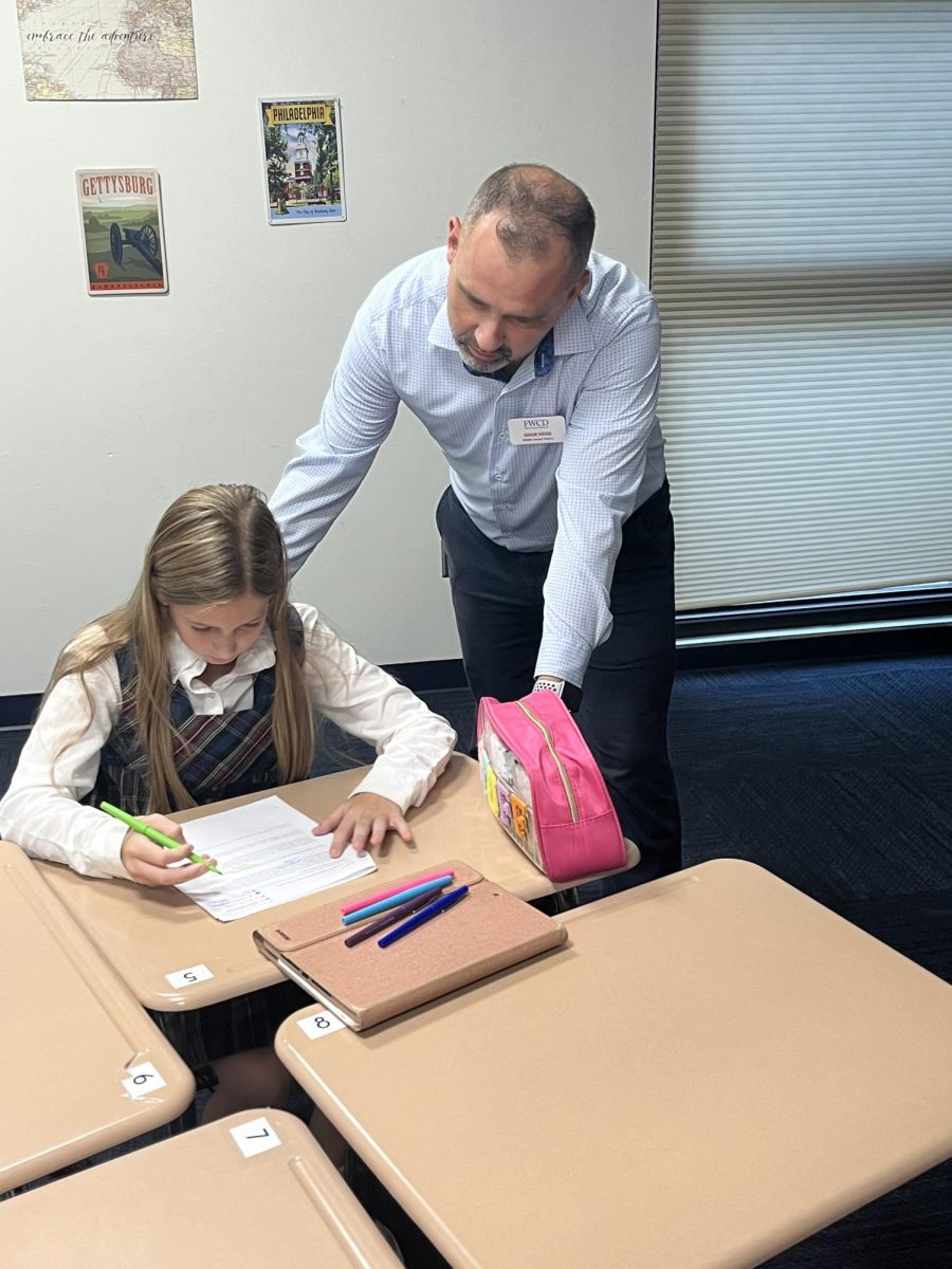 Middle School history teacher Adam Hogg helps Lola Cowden 29 on assignment. 