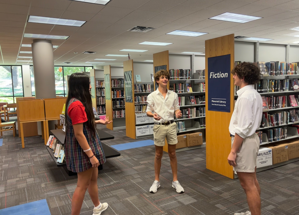 Freshmen talk in the library without the distraction of phones.