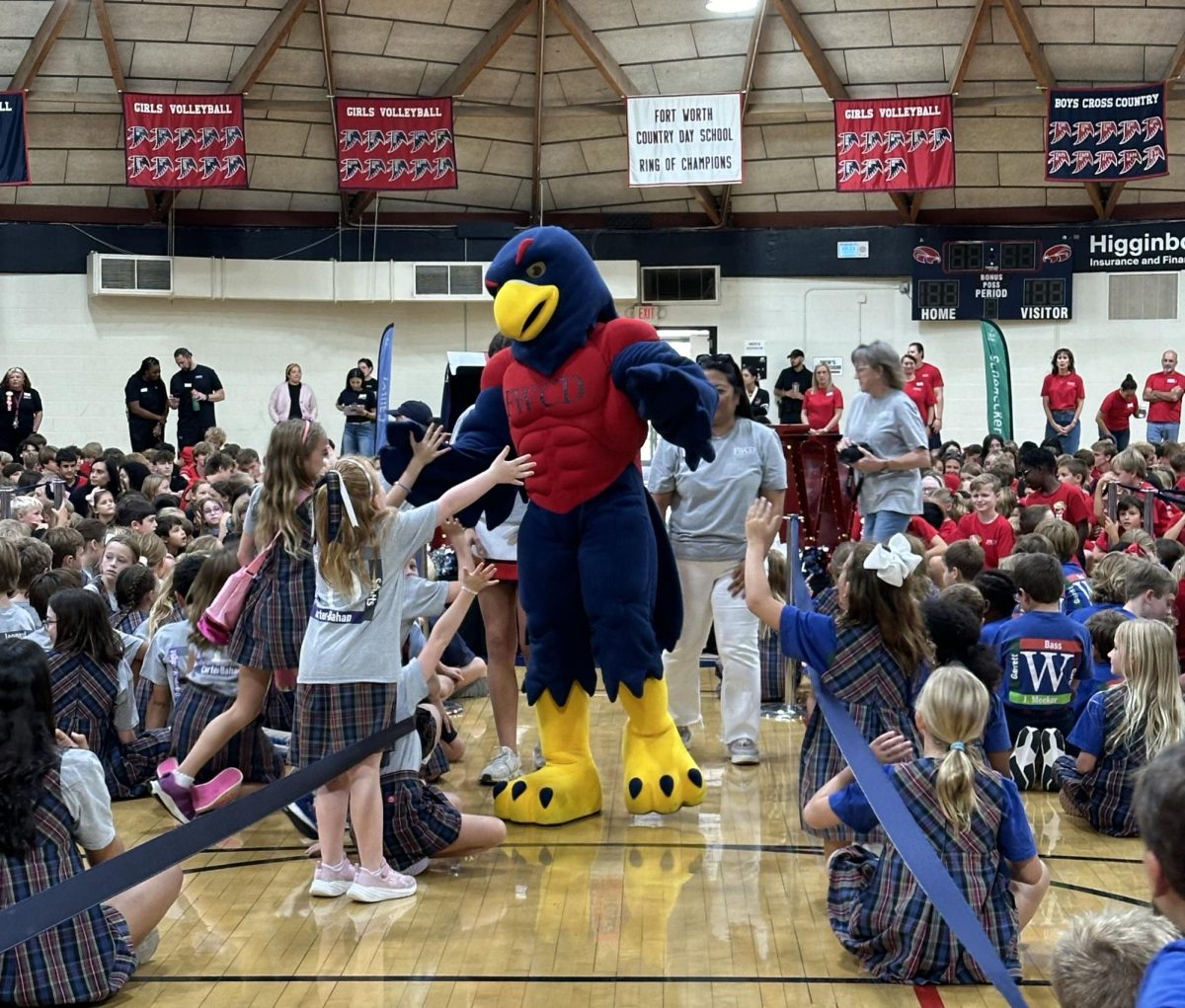 As Convocation begins, Talon welcomes Kindergartener Madison Ray to the Round Gym.