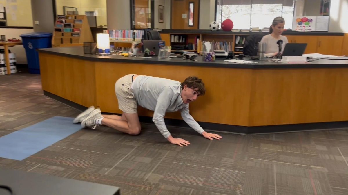 Dawson Decker '26 hides from US Librarian Sarah Blan in the Moncrief Library.