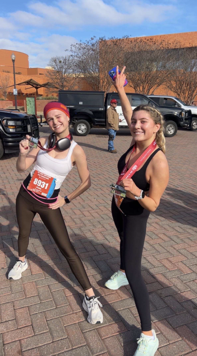 Sloane Factor '26 posing with her medal after finishing the Cowtown Marathon.