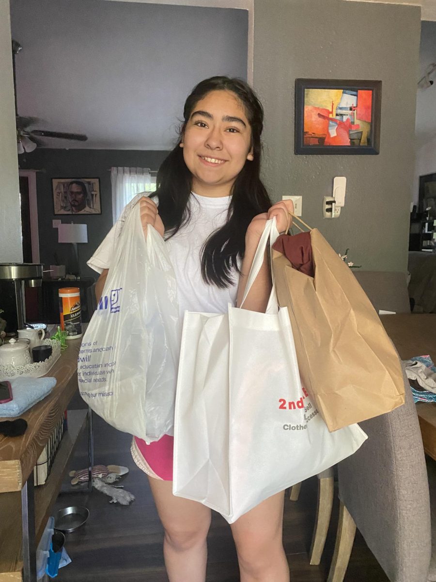 Lorena Manrique '28 shows off her thrift store finds from Fort Worth stores.