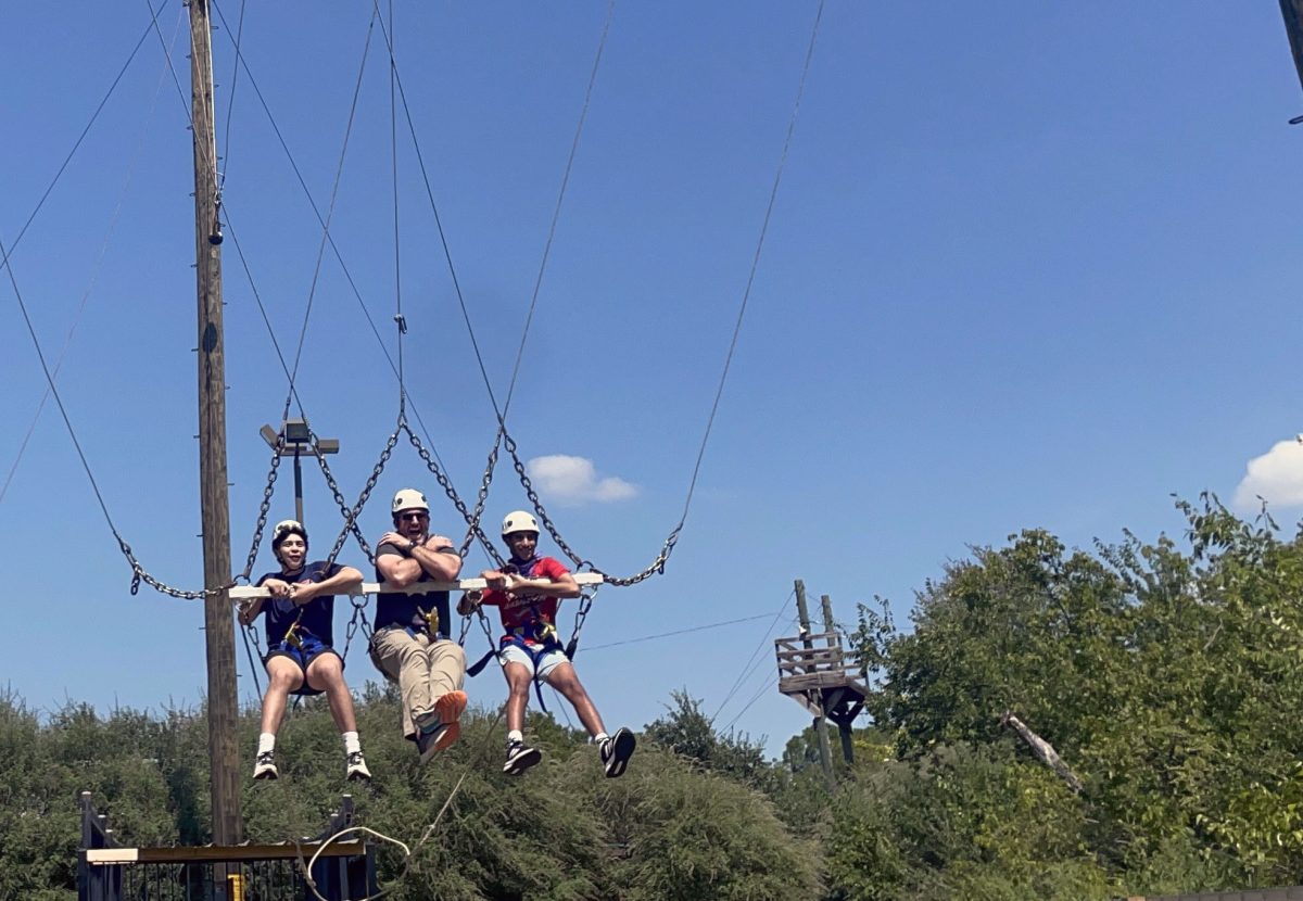 Marcos Zamorano '29, Bennett Mitchell, Aniv Das '29 ride the Tarzan Swing.