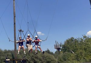 Marcos Zamorano '29, Bennett Mitchell, Aniv Das '29 ride the Tarzan Swing.