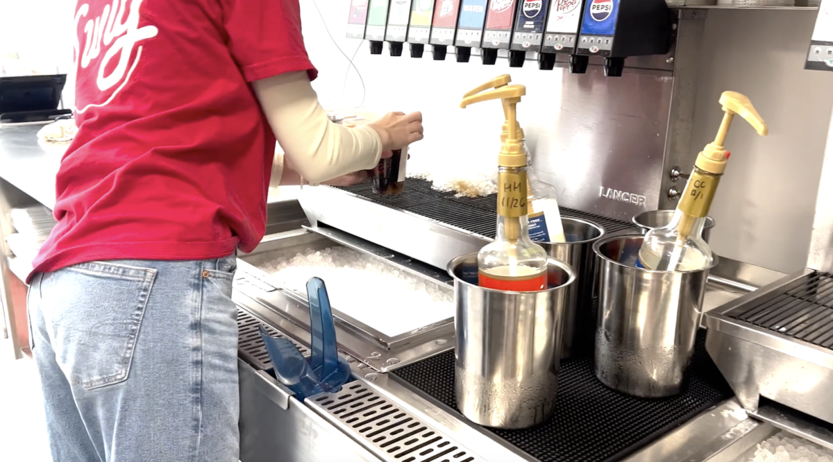 A Swig employee makes a beverage with Dr. Pepper and other flavors.