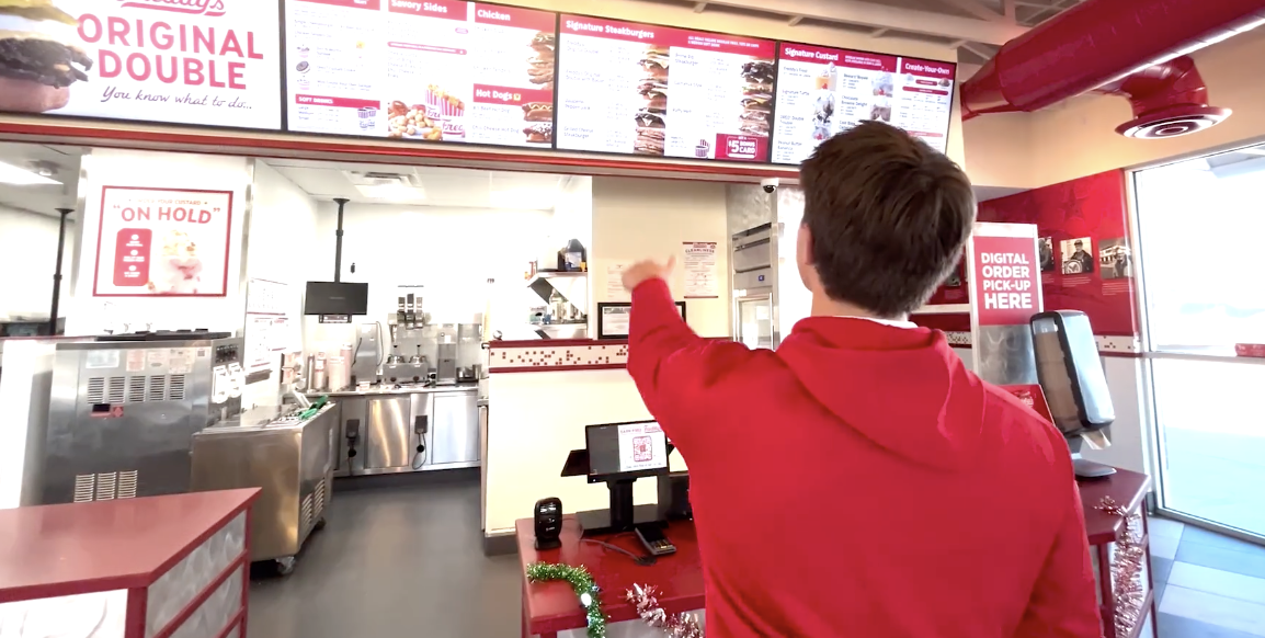 Chase Hatfield '28 browses the menu at Freddy's Frozen Custard and Steakburgers.