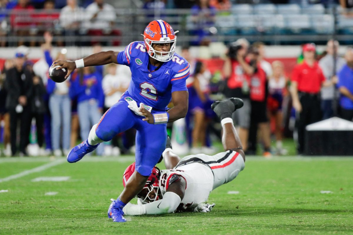 Nov 1, 2025; Jacksonville, Florida, USA; Florida Gators quarterback DJ Lagway (2) scrambles against the Georgia Bulldogs in the fourth quarter at EverBank Stadium. Mandatory Credit: Travis Register-Imagn Images