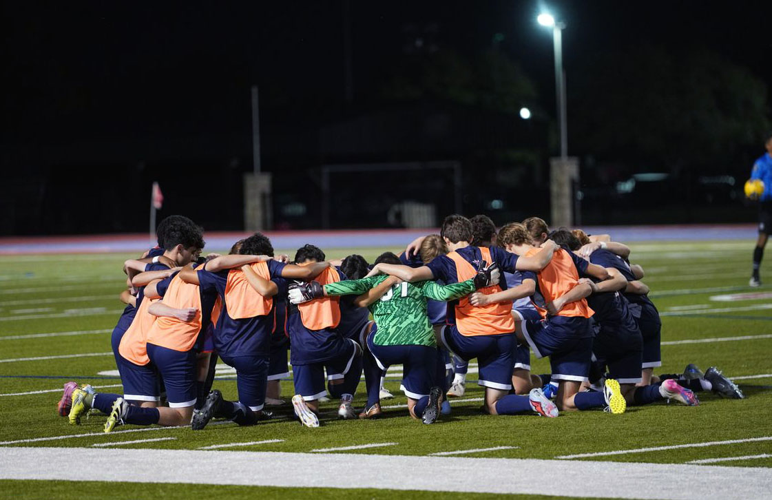 Varsity Boys Soccer Team encourages each other before a game.