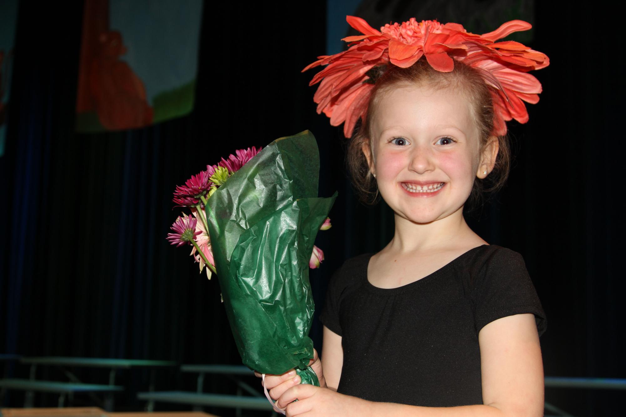 Evie Blan '27 poses with her flowers after her performance as a flower in "The Jungle Book."