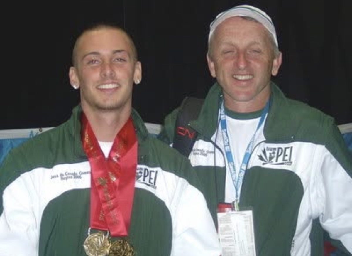 Jared Connaughton, head cross country and track and field coach at FWCD, standing next to Alex Gardiner in Düsseldorf, Germany.