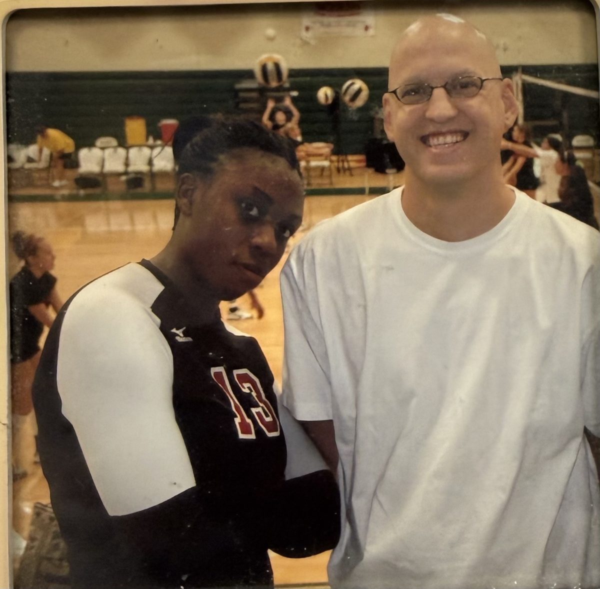 Tatiana Booth, head girls volleyball coach, poses next to her high school coach, following a game.