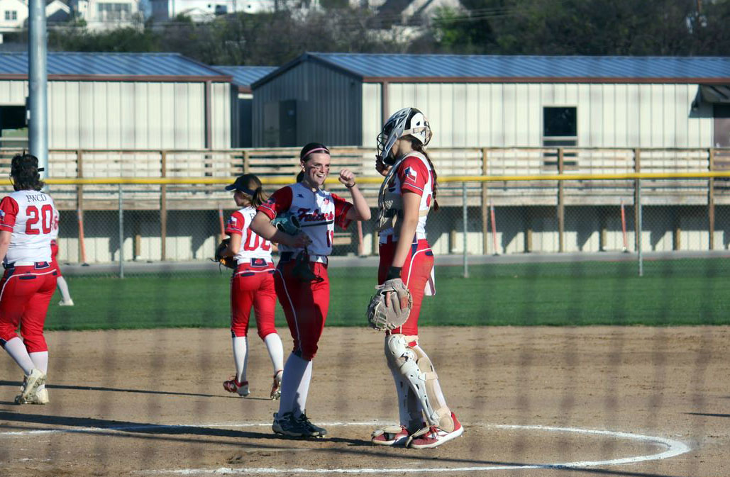 Richey '27 and Ryleigh Hall '27 meet at the mound between plays to encourage each other.
