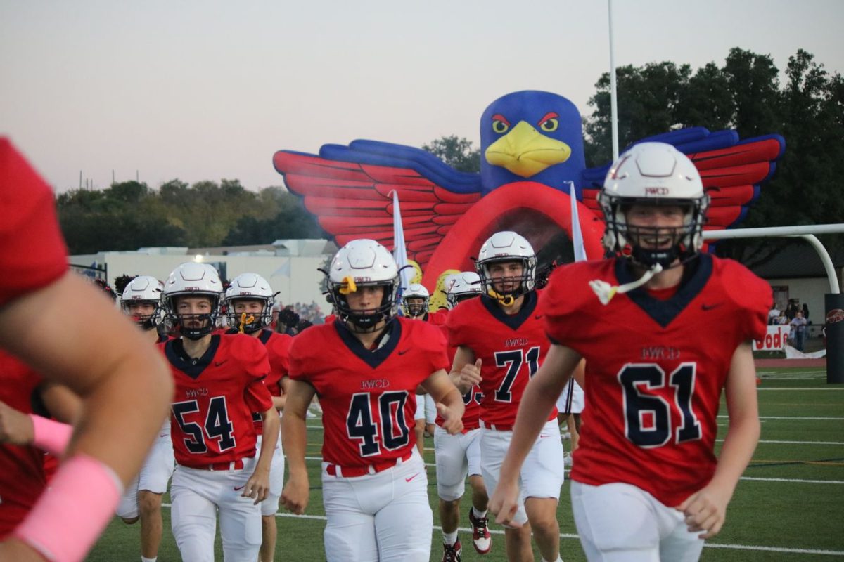 The FWCD Varsity Football team runs out of the tunnel before a football game